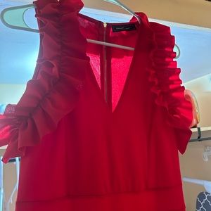 Red Jumpsuit with cute frilly detail at V neck. Wide leg and super flattering.